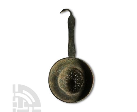 1st-3rd century A.D.. Cup-shaped body with flared and curved rim, flat-section handle with swan-head finial; the body with pi