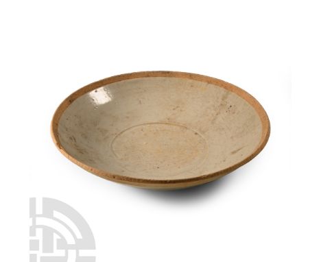 Tang Dynasty, 618-907 A.D. or later. Broad profile with light blue glaze, low basal ring.  173 grams, 15 cm (6 in.). Ex W.C. 