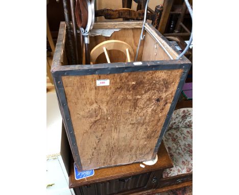 A tea chest containing a shooting stick, four walking sticks, a magazine rack and a hanger. 