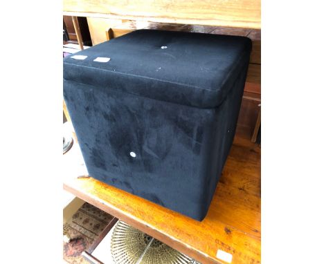 A modern black pouffe. 