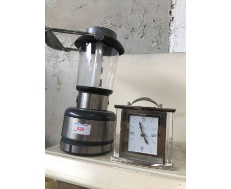 A mantle clock and a battery camping lamp 