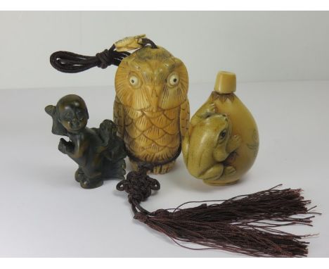 ORIENTAL CARVINGS, a carved bone owl, also carved frog snuff bottle and child and dog, netsuke