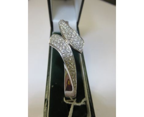 DIAMOND & WHITE GOLD BANGLE, an impressive 18ct white gold hinged bangle encrusted with diamonds, approx 6" dia