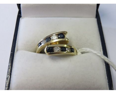 SAPPHIRE & DIAMOND RING, 18ct yellow gold 6 stone sapphire & 4 stone diamond cross over ring, size K/L