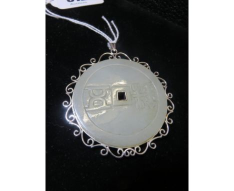 JADE PENDANT, large circular engraved jade pendant in a 14ct white gold mount, 6cm dia