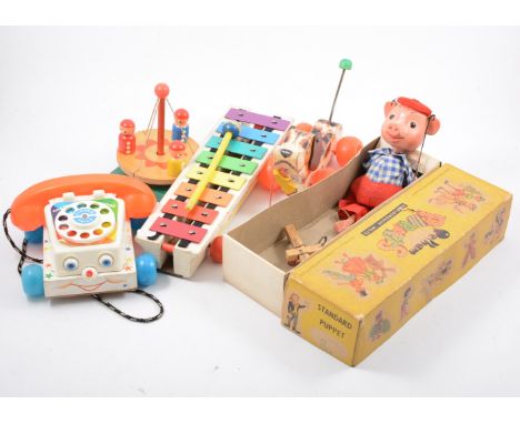 Pelham Puppet; Pinky the Pig boxed, Fisher price pull along dog, xylaphone, telephone and a Susan Wynter wooden spinning toy,