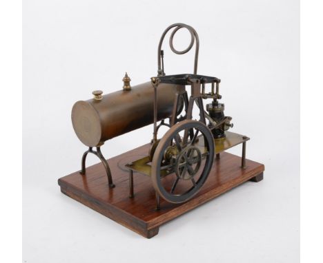 A well built model stationary engine, early 20th Century with flywheel and boiler, mounted on wooden board, 24cm by 20cm. 