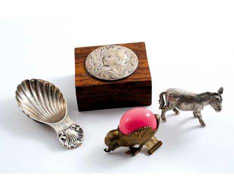 A MIXED LOT: A modern cast miniature model of a donkey, a modern caddy spoon, a novelty brass tape measure in the form of a c