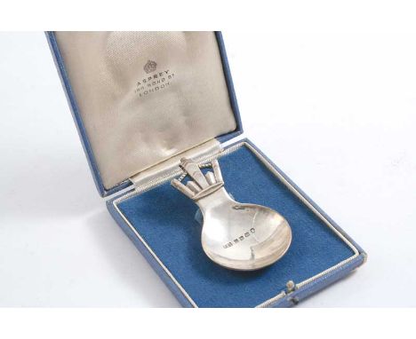 BY R.E. STONE: A Coronation Commemorative caddy spoon with a stylised crown terminal, London 1935, retailed by Asprey (origin