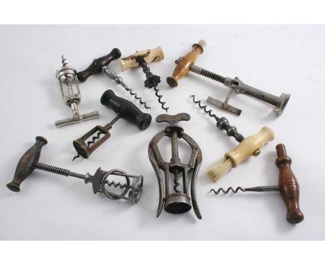A WOODEN HANDLED STEEL CORKSCREW with a "floating" brass body, two bone handled steel corkscrews (one with a brush), a steel 