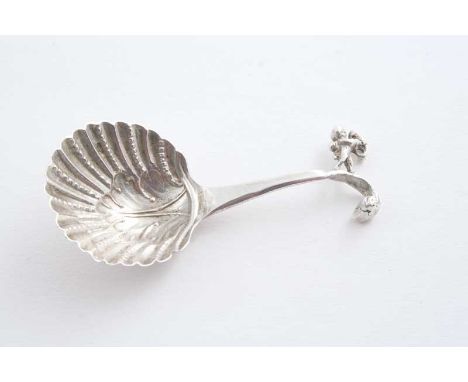 A LATE 19TH / EARLY 20TH CENTURY DUTCH CADDY SPOON with a shell bowl & the figure of cupid firing his arrow on the terminal, 