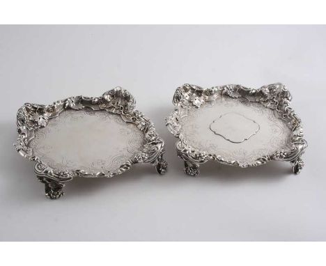 BY PAUL DE LAMERIE: A pair of George II waiters or stands of shaped square outline with cast borders of husks & fruiting vine