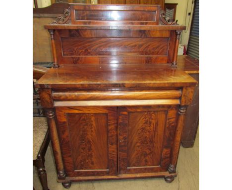 A Victorian mahogany chiffonier with a raised back and shelf, the base with a rectangular top, frieze drawer and a pair of cu