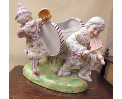 A continental porcelain planter with two clown playing musical instruments