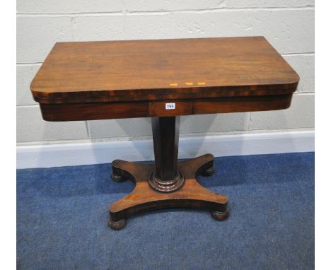 A REGENCY MAHOGANY FOLD OVER CARD TABLE, with a swivel top and storage section, the top enclosing a green baize playing surfa