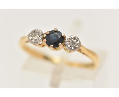 AN 18CT GOLD SAPPHIRE AND DIAMOND RING, set with a central circular cut deep blue sapphire, flanked with illusion set single 