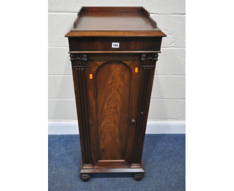 A REGENCY MAHOGANY POT CUPBOARD, with raised gallery back and sides, the single cupboard door with pillar style design, raise