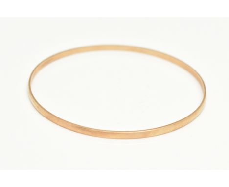 A 9CT GOLD BANGLE, a plain polished solid bangle, approximate width 2.5mm, internal diameter 66mm, hallmarked 9ct London, app