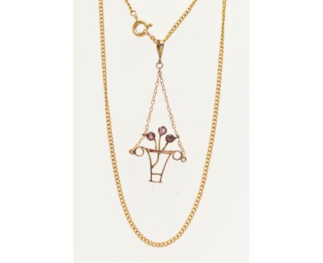 A YELLOW METAL PENDANT AND CHAIN, the pendant in the form of a plant pot with flowers set with rubies, fitted with a tapered 