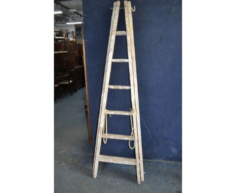A VINTAGE WOODEN SET OF DECORATORS STEP LADDERS with 6 rungs to each 200cm section