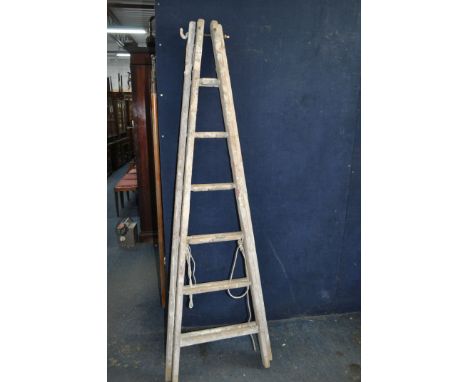 A VINTAGE WOODEN SET OF DECORATORS STEP LADDERS with 6 rungs to each 200cm section