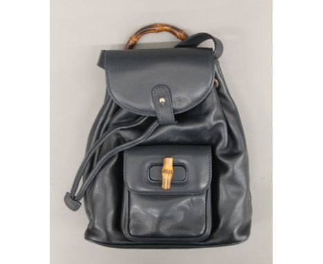 A Gucci bamboo-handled black leather backpack. 25 cm x 21 cm x 9 cm.