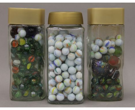 Three jars of vintage marbles.