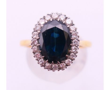An 18 ct gold sapphire and diamond ring.  Ring size R.