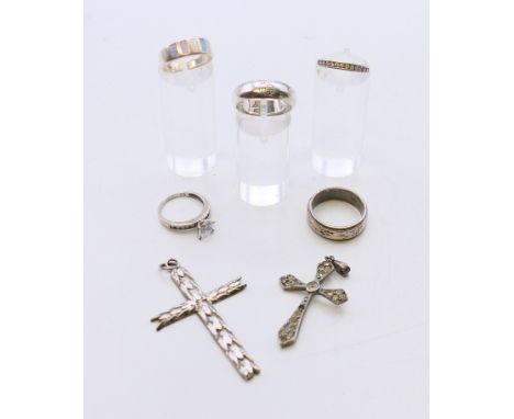 Five silver rings and two silver pendant crosses. 33 grammes.  Largest cross 5.5 cm high, solitaire ring size K.