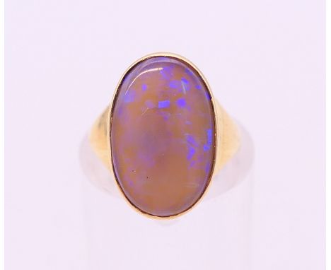 An 18 ct gold and black opal ring. Ring size G/H.