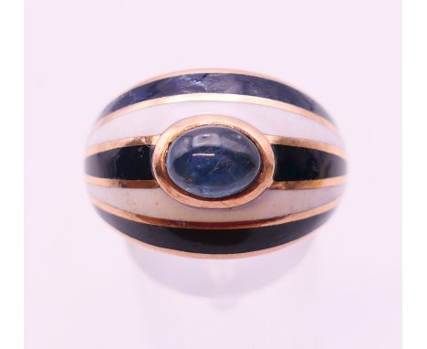 A 9 ct gold and enamel cabochon sapphire set ring. Ring size S.