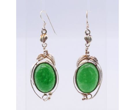 A pair of silver and jade earrings. Each 4 cm high. 