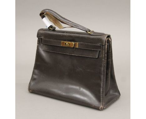 A dark brown Hermes year 'K' 1955 Kelly handbag. 21 cm high x 29 cm wide x 13 cm deep.