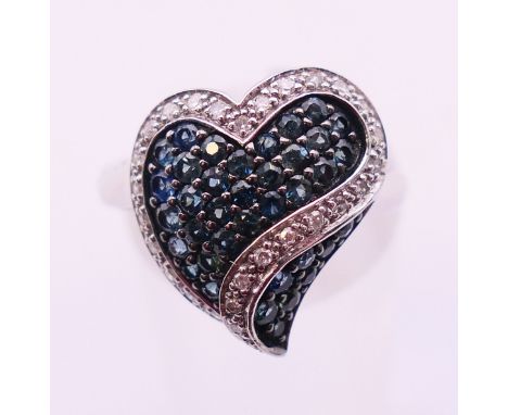 A 10 K white gold sapphire and diamond heart form ring. Ring size O.