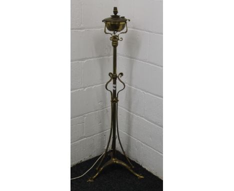 An Art Nouveau brass standard lamp. 133 cm high.