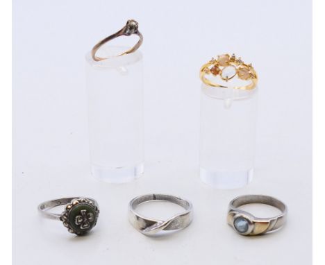 A 9ct gold ring and four dress rings. The former ring size K/L.