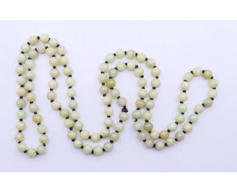 A string of celadon jade beads. 120 cm long.