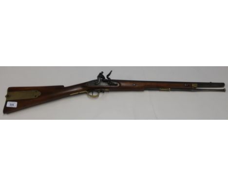 Flintlock carbine with 22 inch barrel with brass mounts and butt compartments with steel ramrod, the barrel marked Dublin, th