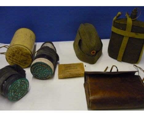 Selection of various assorted military items including water canteen, First Aid pouches, gas masks, German side cap, axe head