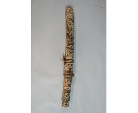 Japanese dagger with 10 1/2 inch blade with carved bone grip and scabbard decorated with various figures and foliage 