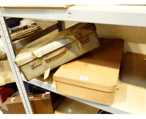 Two vintage suitcases, one leather