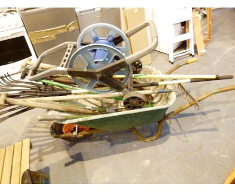 Large plastic wheelbarrow with collection of gardening tools
