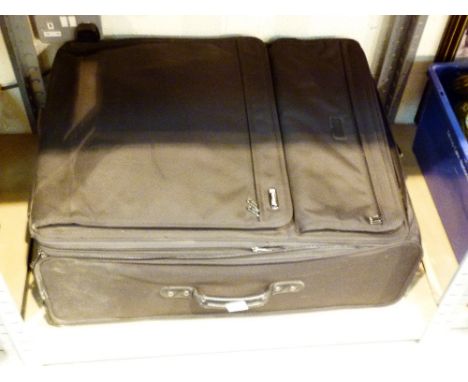 Large canvas suitcase containing vintage curtains