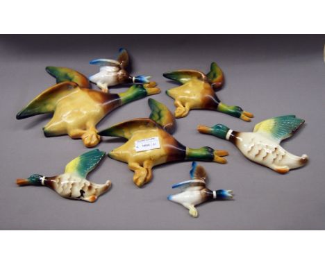 A set of three and two sets of two, ceramic flying mallards 