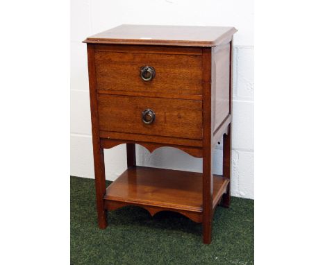 A late Victorian oak two drawer chest with an under-shelf