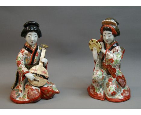 A pair of Japanese gilt and painted ceramic figural studies, each approximately 22cm high
