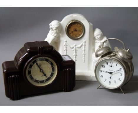 An Art Deco bakelite electric mantle clock together with a 19th Century clock movement having a leter plaster surround and an