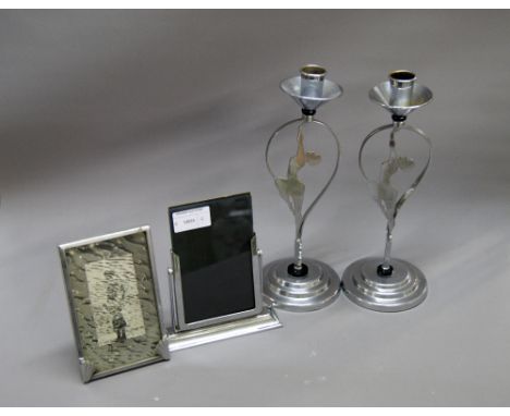 Pair of Art Deco chromed candlesticks and two photograph frames