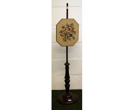 A mahogany pole-screen with a lozenge-shaped wool-work panel