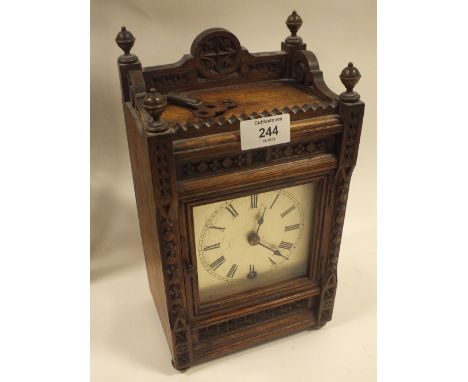 AN ANTIQUE OAK CARVED MANTLE CLOCK